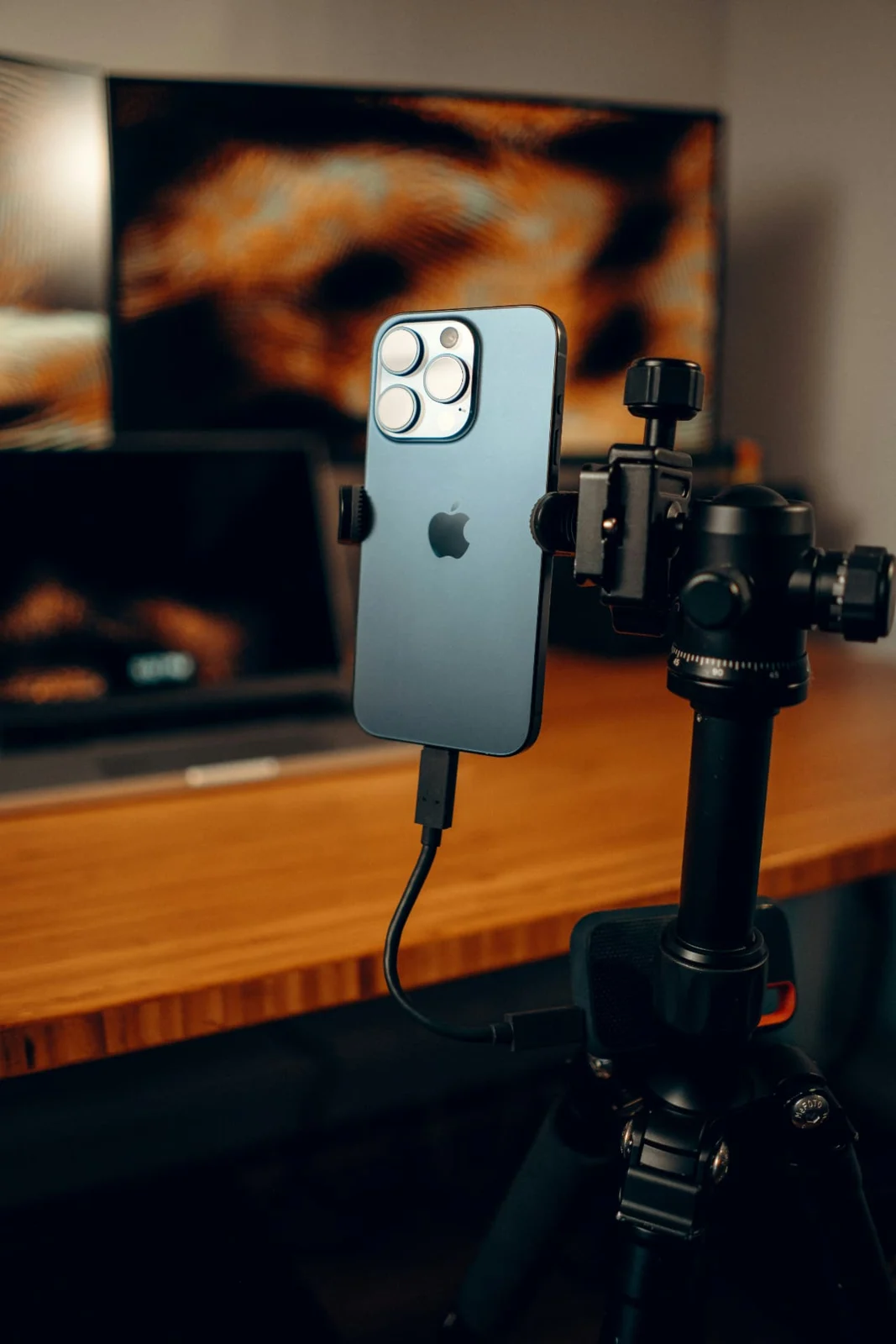 A smartphone mounted on a stabiliser for filming