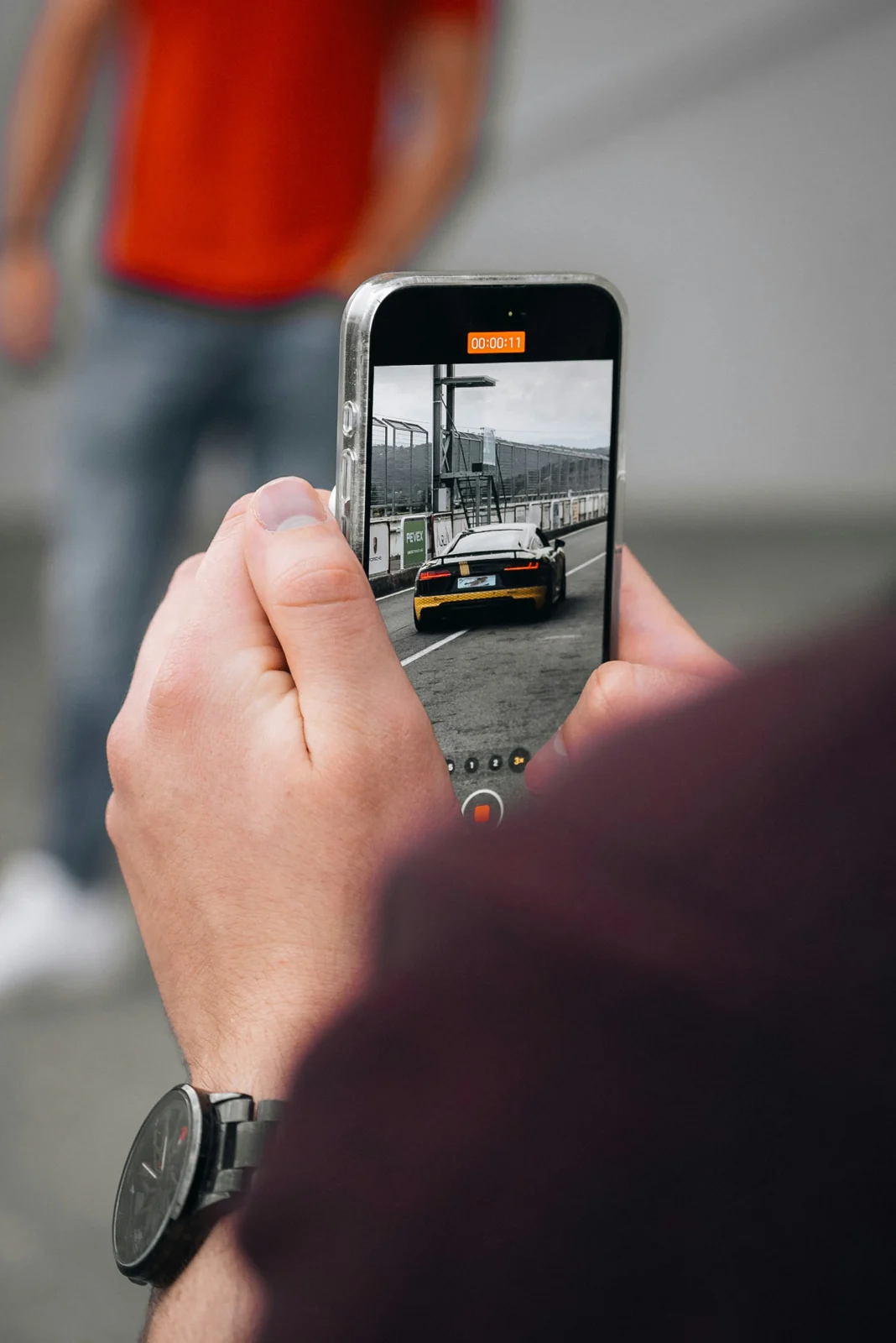 A creator capturing footage on a handheld smartphone