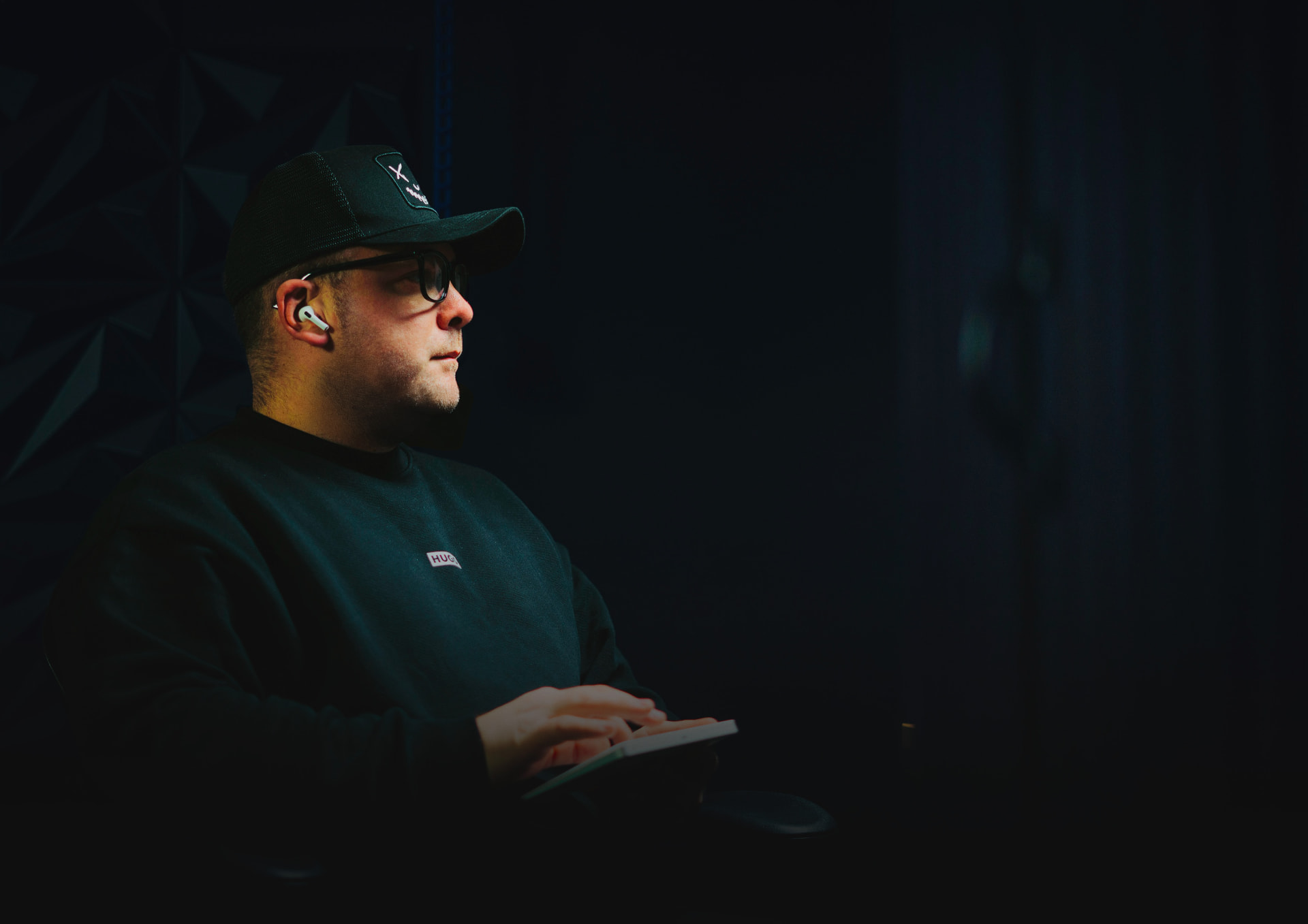 Stuart Forsyth working at a keyboard in a dimly lit studio